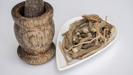 Hog weed, Boerhavia diffusa, dried roots, on white ceramic bowl.