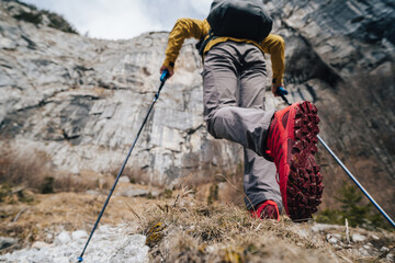 Hiking or trail running in the mountains. Outdoor cross-country running in mountains. Hiking, exercising, fitness and healthy lifestyle.