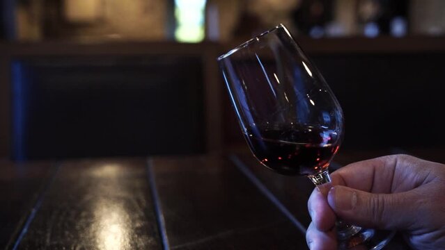 port wine testing, glasses with drink woman holding one