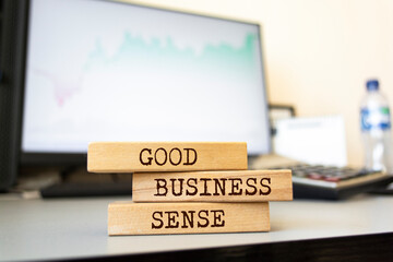 Wooden blocks with words 'GOOD BUSINESS SENSE'. Business concept