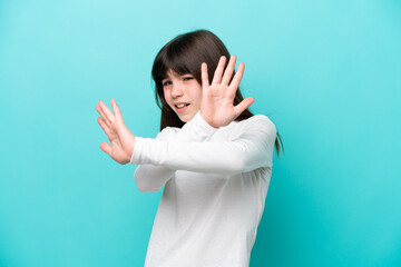 Fototapeta premium Little caucasian girl isolated on blue background nervous stretching hands to the front