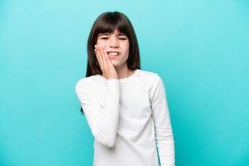 Little caucasian girl isolated on blue background with toothache