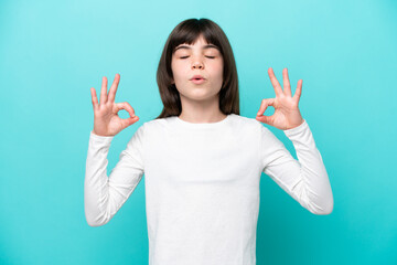 Fototapeta premium Little caucasian girl isolated on blue background in zen pose