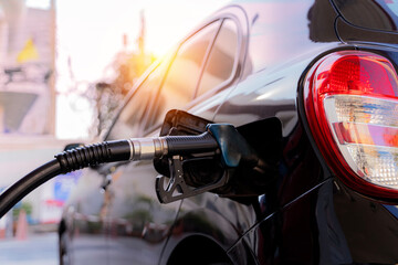 car gas nozzle automatic refueling Refueling with premium gasoline at a gas station Close up gas...