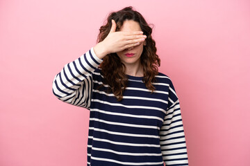 Young caucasian woman isolated on pink background covering eyes by hands. Do not want to see...