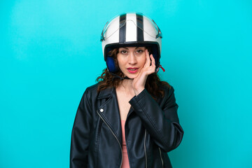 Young caucasian woman with a motorcycle helmet isolated on blue background thinking an idea