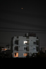 A beautiful night view of a city life with a dark, clear sky, dense, tall buildings with lights on...