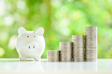A cheerful piggybank with stacks of shiny coins nearby, representing smart savings strategies. Each...