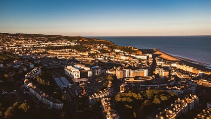 Obraz premium Aerial view of a unique tropical town and the sea in England at sunset