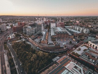 Aerial view of the Kings Cross rail hub under a cinematic sunset sky
