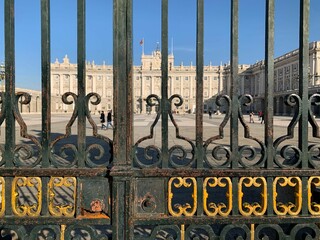 Metallic rustic gates on the Royal Palace of Madrid in Spain under the blue sky