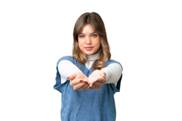 Young girl over isolated chroma key background holding copyspace imaginary on the palm to insert an ad