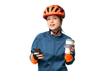 Young cyclist girl over isolated chroma key background holding coffee to take away and a mobile