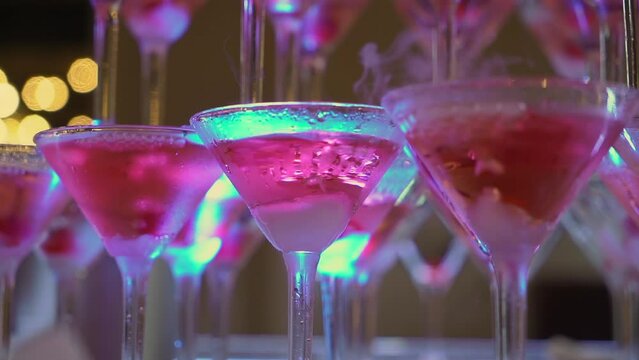 Tower of glasses at celebration party. Welcome drinks, tower of champagne or sparkling wine with red berry. Restaurant ready for reception. Alcoholic beverage.