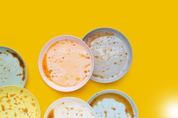 Dirty dishes on yellow background. Top view
