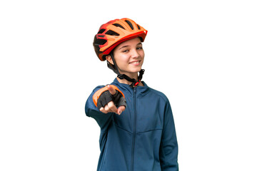 Teenager cyclist girl over isolated chroma key background points finger at you with a confident expression