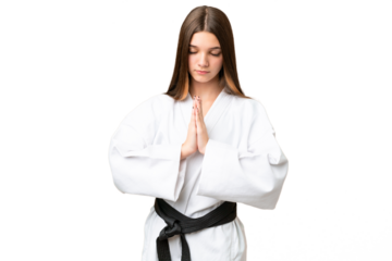 Teenager girl over isolated chroma key background doing karate and saluting