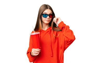 Teenager girl in a cinema over isolated chroma key background having doubts and thinking