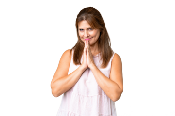 Middle age woman over isolated background keeps palm together. Person asks for something