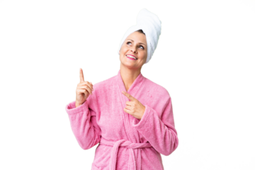 Middle age caucasian woman in a bathrobe over isolated background pointing with the index finger a great idea
