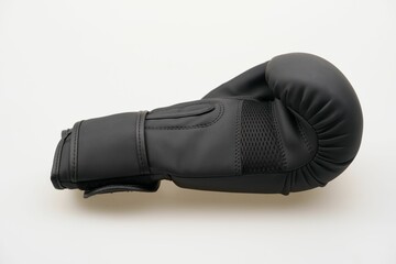 Single black boxing glove isolated on a white background