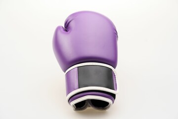 Single purple boxing glove isolated on a white background