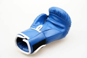 Single blue boxing glove isolated on a white background