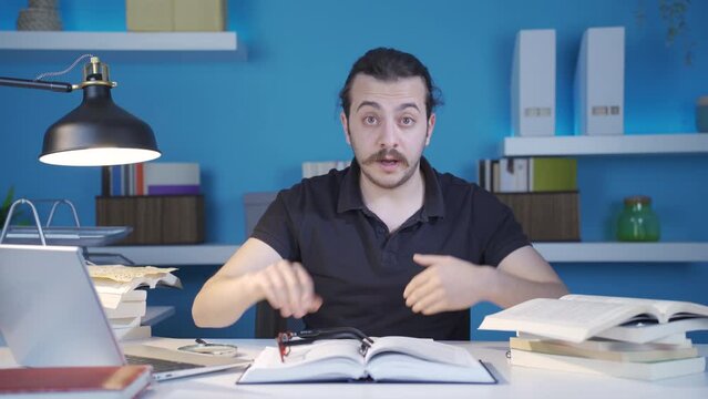 Man giving motivational and pep talk.
Man working in his office looks at camera and gives motivational and inspirational speech.
