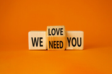 We love and need You symbol. Turned wooden cubes with words We need you and We love you. Beautiful orange background. Business and We love and need You concept. Copy space