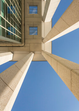 Worm's eye view of a brutalist building from its pillars