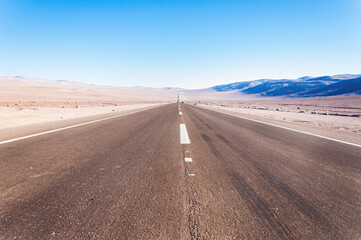 Fototapeta na wymiar Road in the barren landscape of the Atacama Desert in Chile