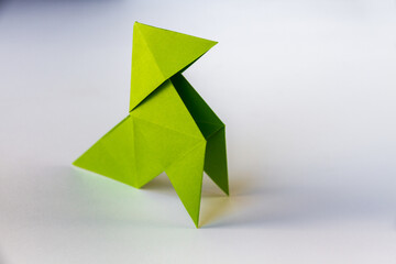 Green paper hen origami isolated on a white background