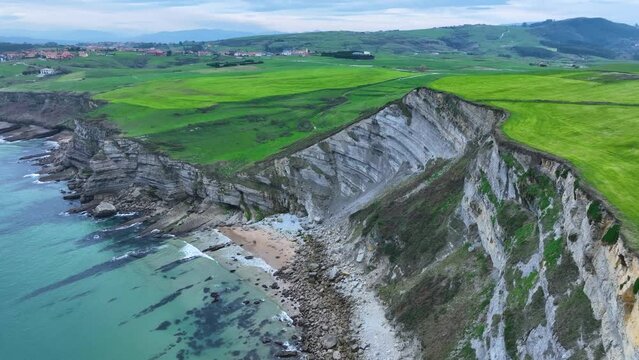 Coastal landscape of cliffs, meadows and sea in the area of Punta Ballota between Tagle and Ubiarco. Aerial view from a drone. Cantabrian Sea. Cantabria, Spain, Europe