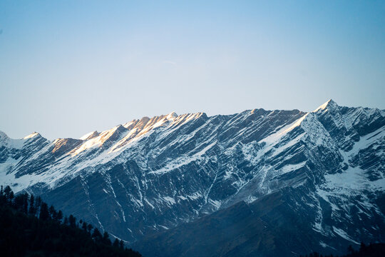 rocky himalayan peaks with snow covering the top against the blue sky showing the beauty of leh ladakh spiti valley