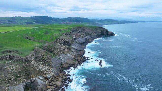 Coastal landscape of cliffs, meadows and sea in the area of Punta Ballota between Tagle and Ubiarco. Aerial view from a drone. Cantabrian Sea. Cantabria, Spain, Europe
