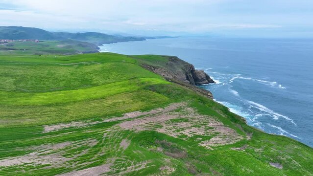 Coastal landscape of cliffs, meadows and sea in the area of Punta Ballota between Tagle and Ubiarco. Aerial view from a drone. Cantabrian Sea. Cantabria, Spain, Europe