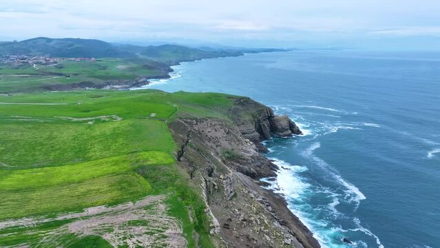 Coastal landscape of cliffs, meadows and sea in the area of Punta Ballota between Tagle and Ubiarco. Aerial view from a drone. Cantabrian Sea. Cantabria, Spain, Europe
