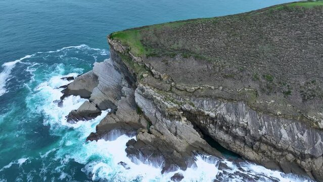 Coastal landscape of cliffs, meadows and sea in the area of Punta Ballota between Tagle and Ubiarco. Aerial view from a drone. Cantabrian Sea. Cantabria, Spain, Europe