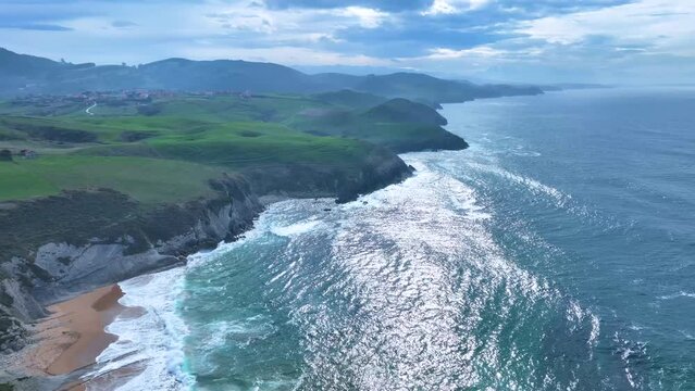 Coastal landscape of cliffs, meadows and sea in the area of Punta Ballota between Tagle and Ubiarco. Aerial view from a drone. Cantabrian Sea. Cantabria, Spain, Europe