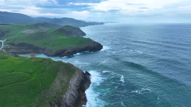 Coastal landscape of cliffs, meadows and sea in the area of Punta Ballota between Tagle and Ubiarco. Aerial view from a drone. Cantabrian Sea. Cantabria, Spain, Europe