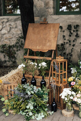 Wooden easel with a board. On the board you can write Welcome. Rustic wedding decor.