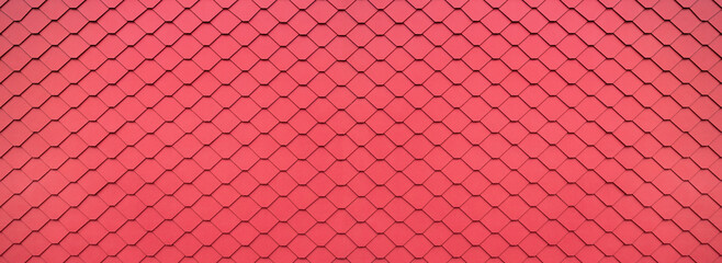 Red Eternit shingles in honeycomb covering - cladding of a facade in panoramic close-up