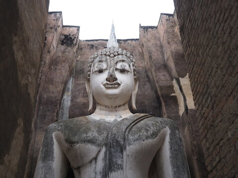 Seated Buddha image (Phra Atchana) at Wat Si Chum temple in Sukhothai Historical Park, a UNESCO world heritage site, Thailand