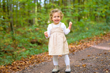 Little smiling girl in the forest