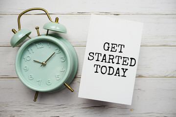 Get Started Today text message with alarm clock on wooden background