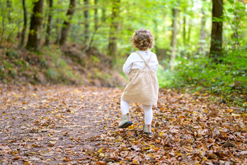 Little girl from behind in the forest