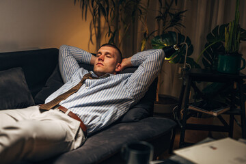 Fototapeta na wymiar A businessman fell asleep on the sofa