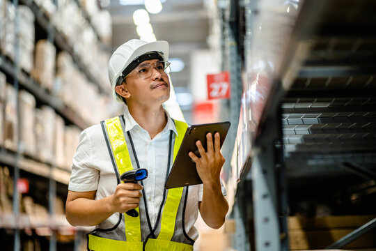 Warehouse workers use scanner checking and scan the barcode of stock inventory to keep storage in a system, Smart warehouse management system, Supply chain and logistic network technology concept.