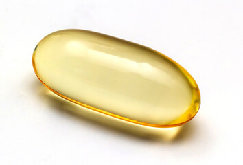 Fish oil capsules omega 3 on light background. Transparent yellow capsules of fish oil