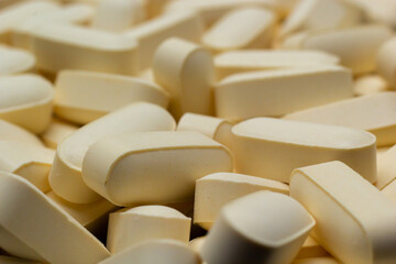 Macro Close up of white painkiller tablet on a reflective black background